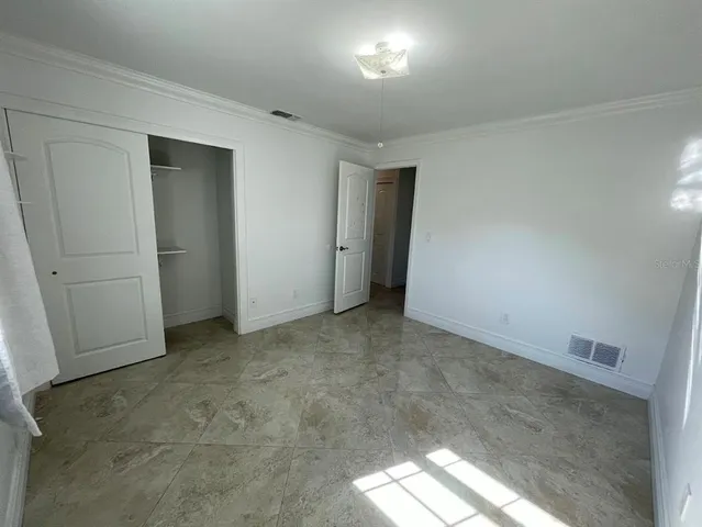 a view of an empty room and a window