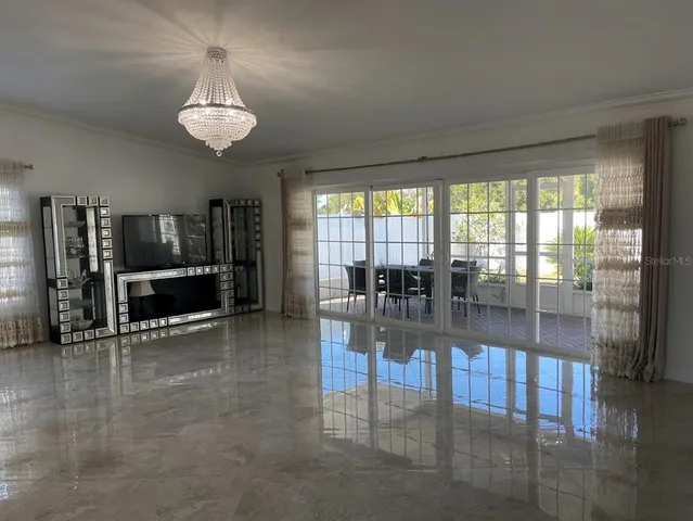 a view of a livingroom with furniture wooden floor and a floor to ceiling window