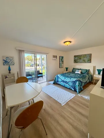 a bedroom with furniture and a large window