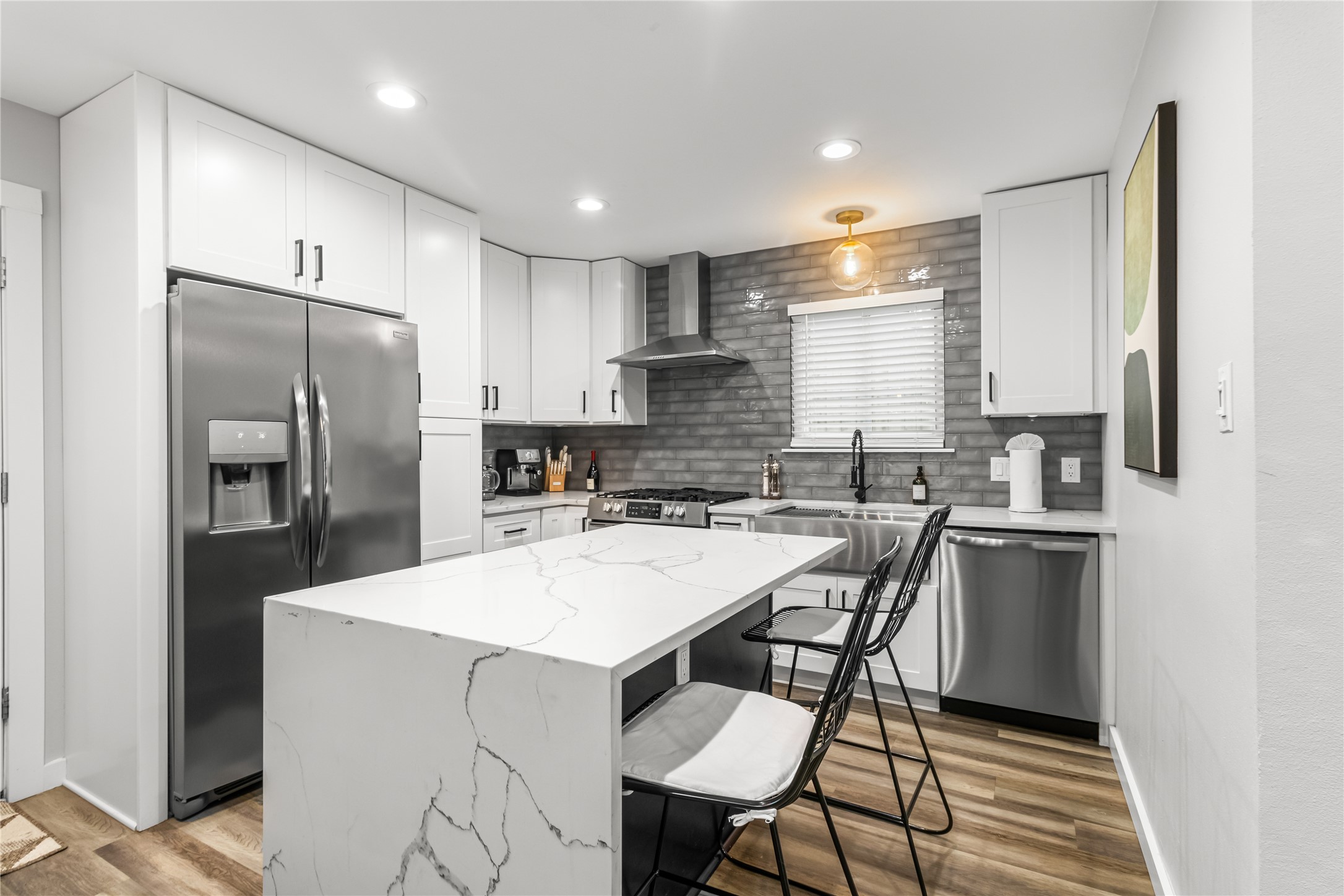 5405 Meadow Crest Austin, TX 78744 - Photo 12 of 33 a kitchen with a refrigerator a sink a stove a dining table and chairs