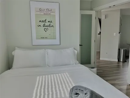 a bedroom with a bed and a view of a bathroom