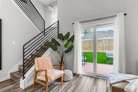 a living room with a balcony furniture and a large window
