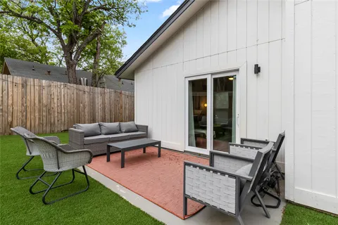 a view of a patio with a table and chairs