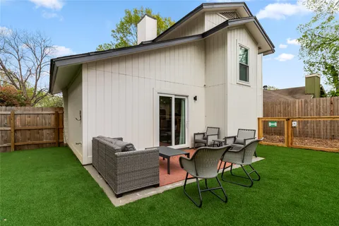 a backyard of a house with table and chairs