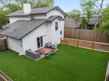 a backyard of a house with table and chairs