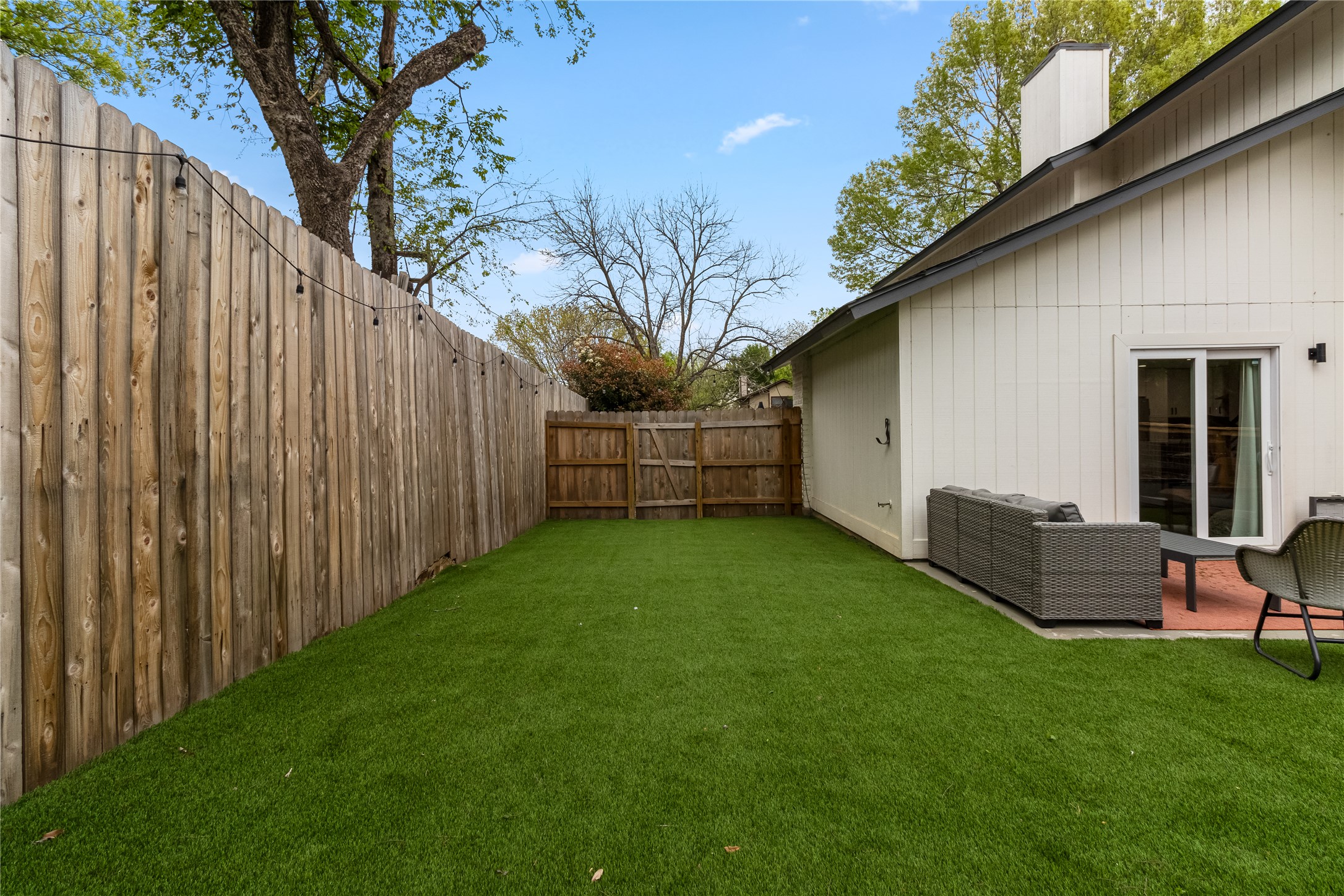 5405 Meadow Crest Austin, TX 78744 - Photo 26 of 33 a view of backyard with wooden fence and a large tree