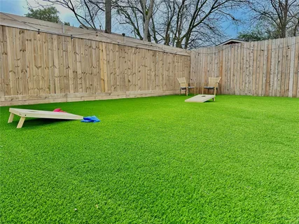 a view of yard with wooden fence