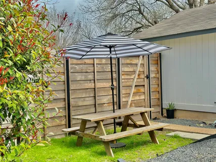 a view of house with backyard and sitting area