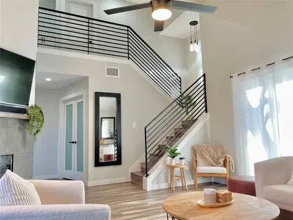 a living room with furniture and a chandelier