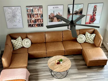 a view of a hallway with furniture and wooden floor