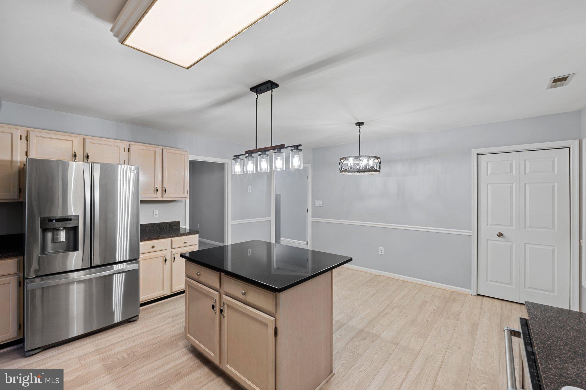 1420 Fishel Road Winchester, VA 22602 - Photo 11 of 34 a kitchen with stainless steel appliances a sink a refrigerator a stove and white cabinets
