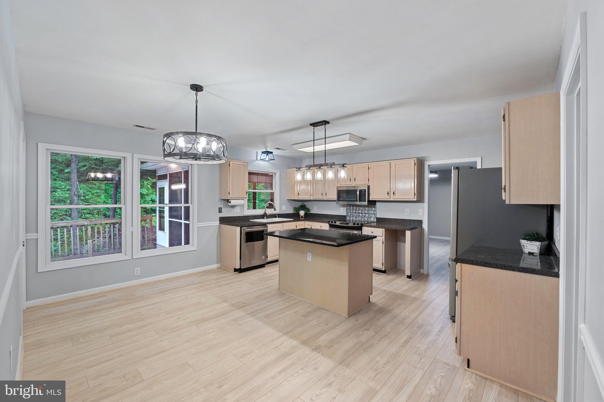 1420 Fishel Road Winchester, VA 22602 - Photo 12 of 34 a view of a kitchen with granite countertop stainless steel appliances and a center island