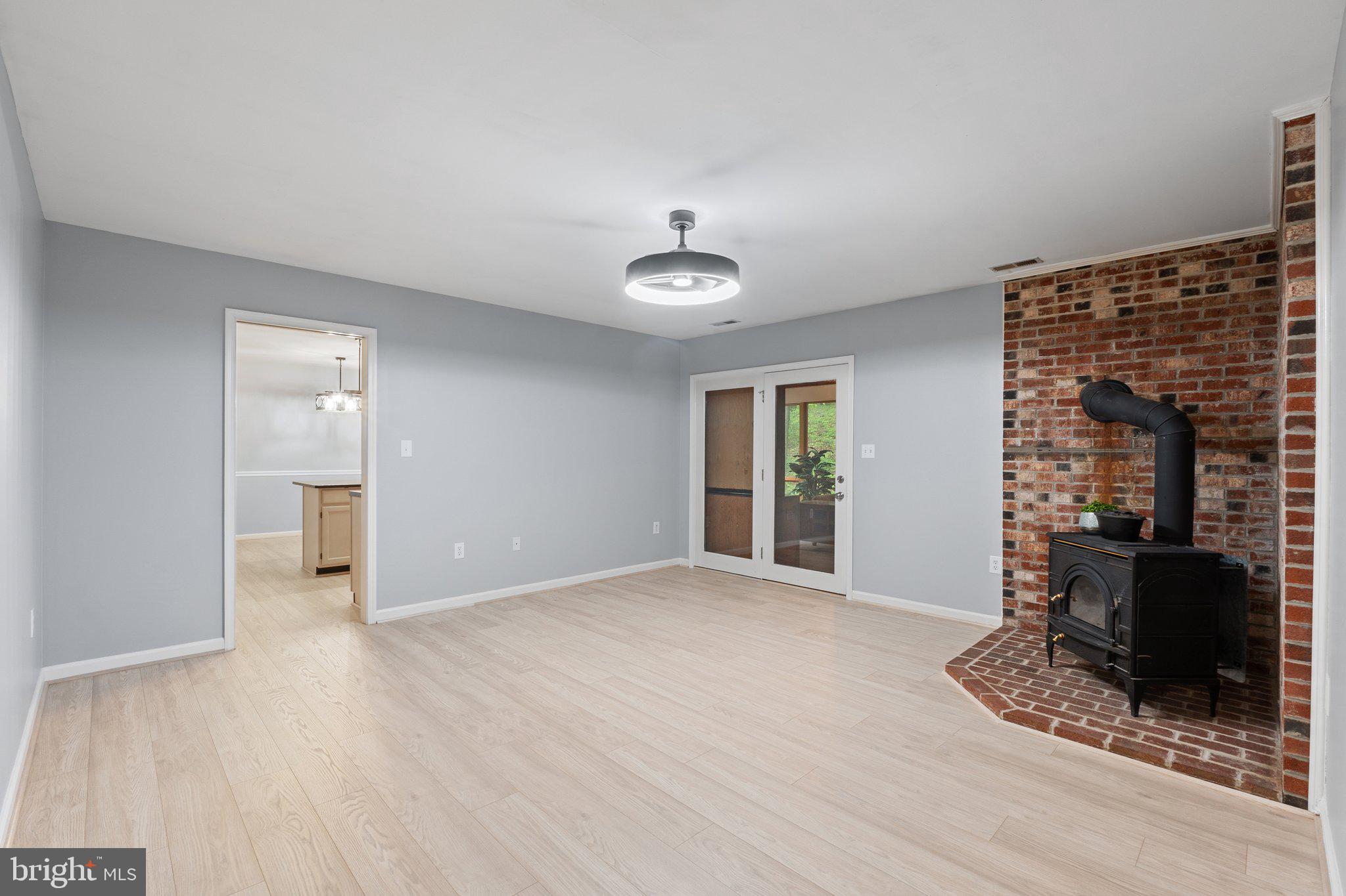 1420 Fishel Road Winchester, VA 22602 - Photo 13 of 34 a view of a livingroom with wooden floor and a ceiling fan