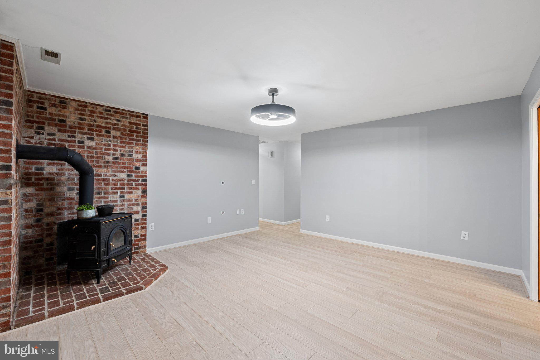 1420 Fishel Road Winchester, VA 22602 - Photo 14 of 34 a view of empty room with wooden floor and fireplace