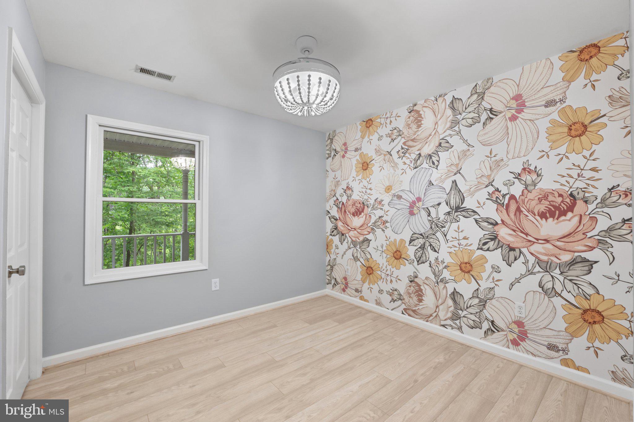 1420 Fishel Road Winchester, VA 22602 - Photo 22 of 34 a view of an empty room and window with wooden floor