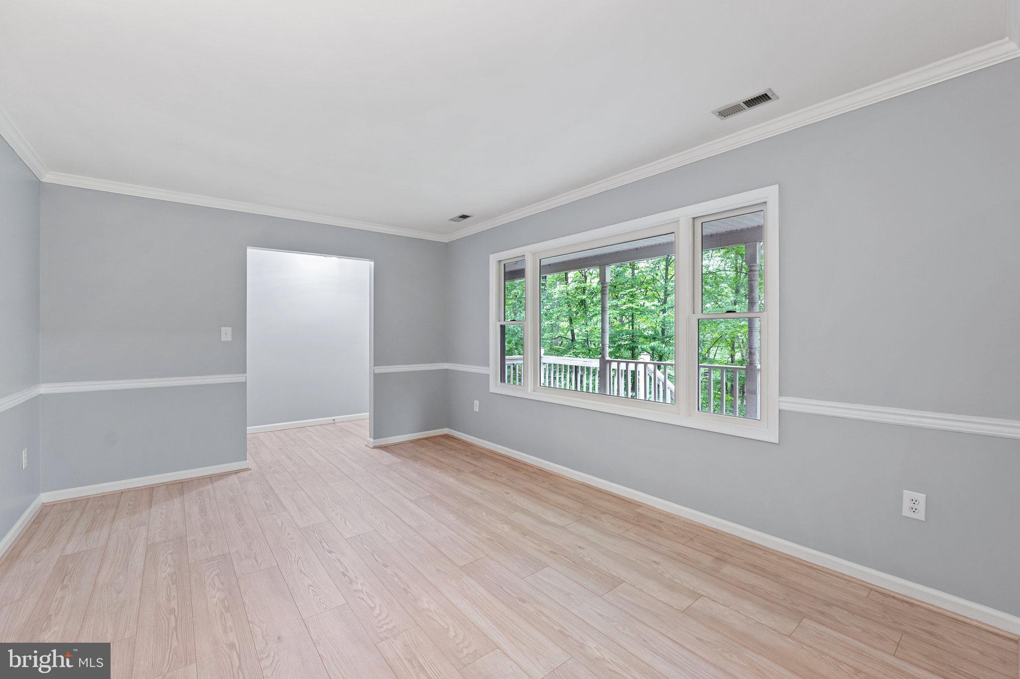 1420 Fishel Road Winchester, VA 22602 - Photo 6 of 34 a view of an empty room with wooden floor and a window