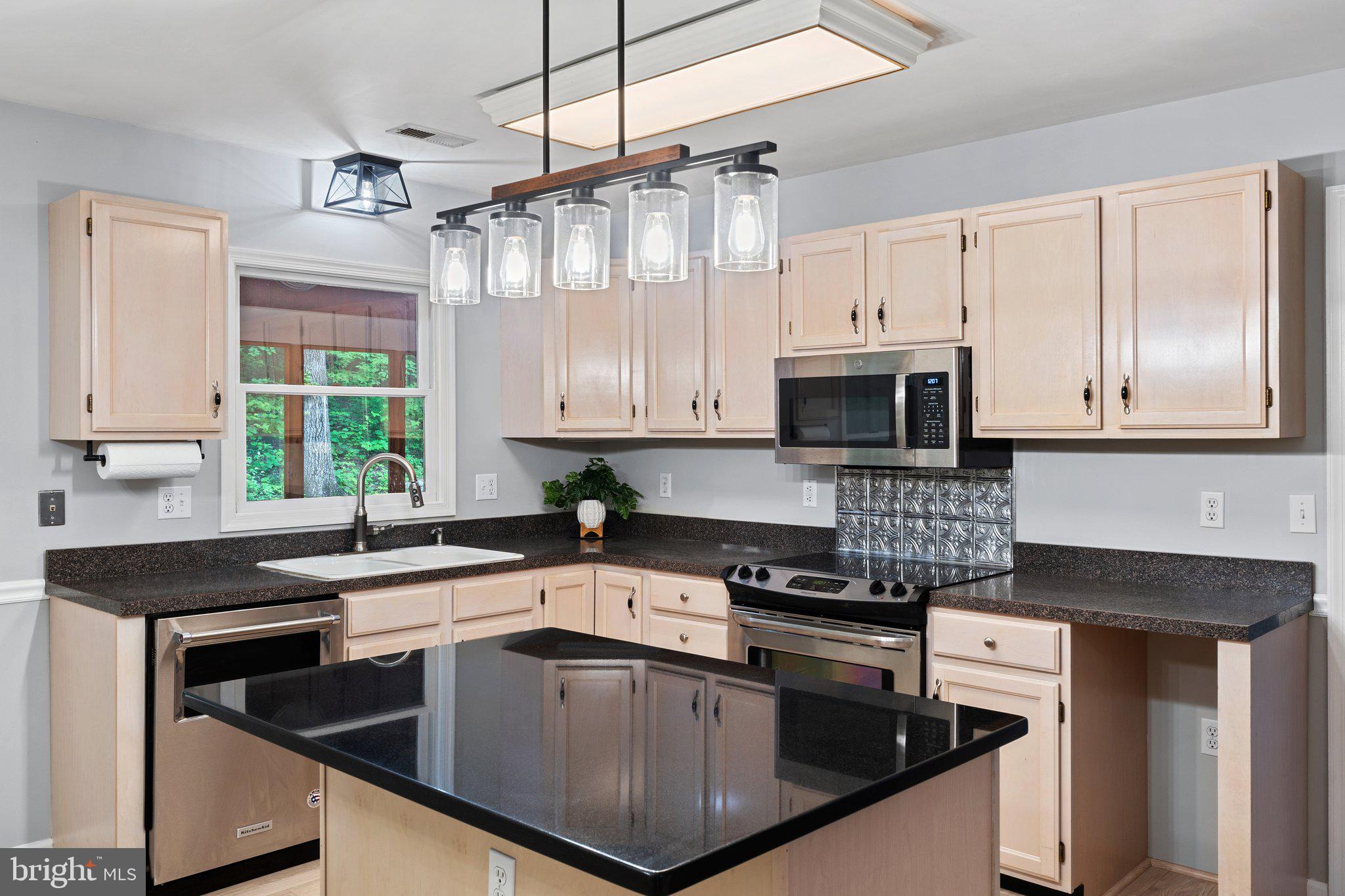 1420 Fishel Road Winchester, VA 22602 - Photo 9 of 34 a kitchen with stainless steel appliances a stove a sink and a microwave