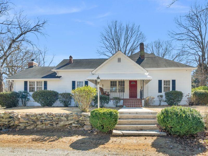 9300 Floyd Road Jonesboro, GA 30236 - Photo 1 of 34 a front view of a house with garden
