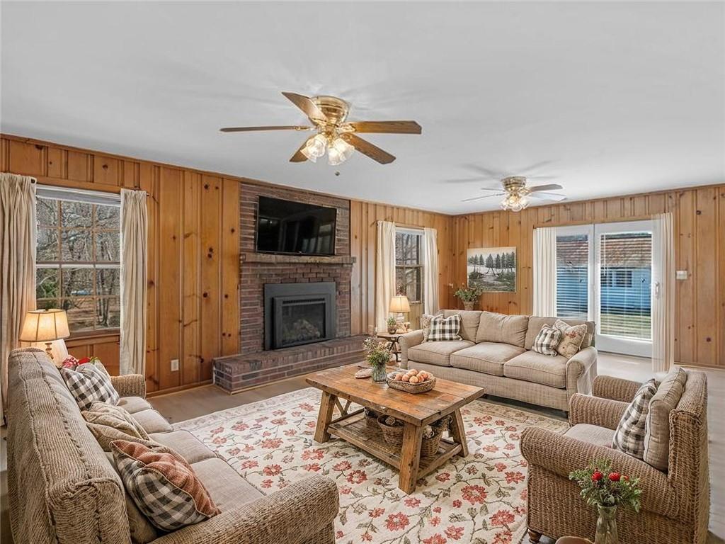 9300 Floyd Road Jonesboro, GA 30236 - Photo 11 of 34 a living room with furniture a fireplace and a flat screen tv