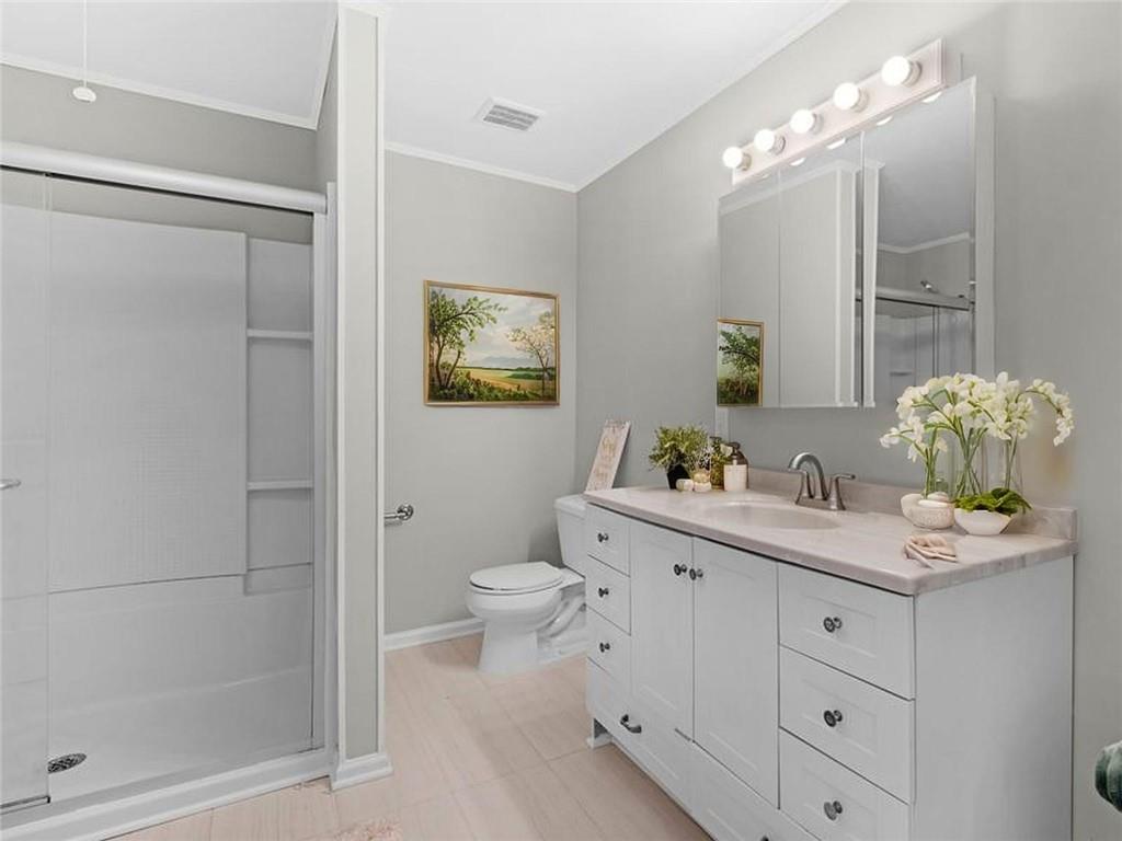 9300 Floyd Road Jonesboro, GA 30236 - Photo 17 of 34 a bathroom with a toilet sink and mirror