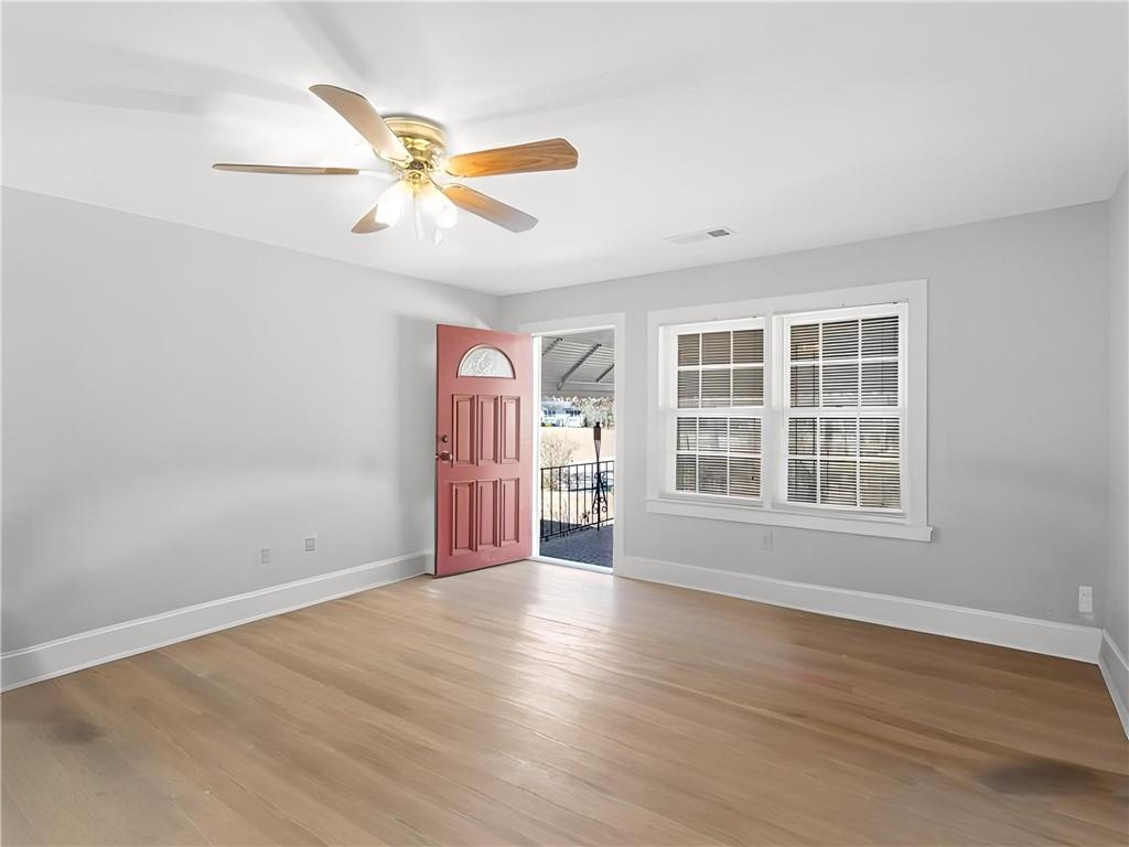 9300 Floyd Road Jonesboro, GA 30236 - Photo 3 of 34 wooden floor in an empty room with a window