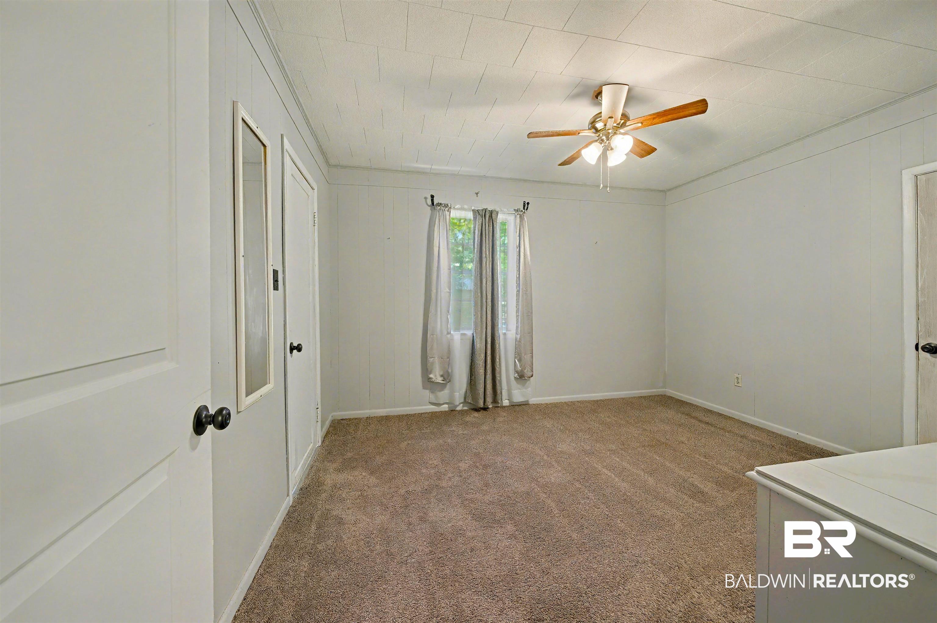 209 West Magnolia Avenue Foley, AL 36535 - Photo 15 of 23 Bedroom featuring carpet and a ceiling fan