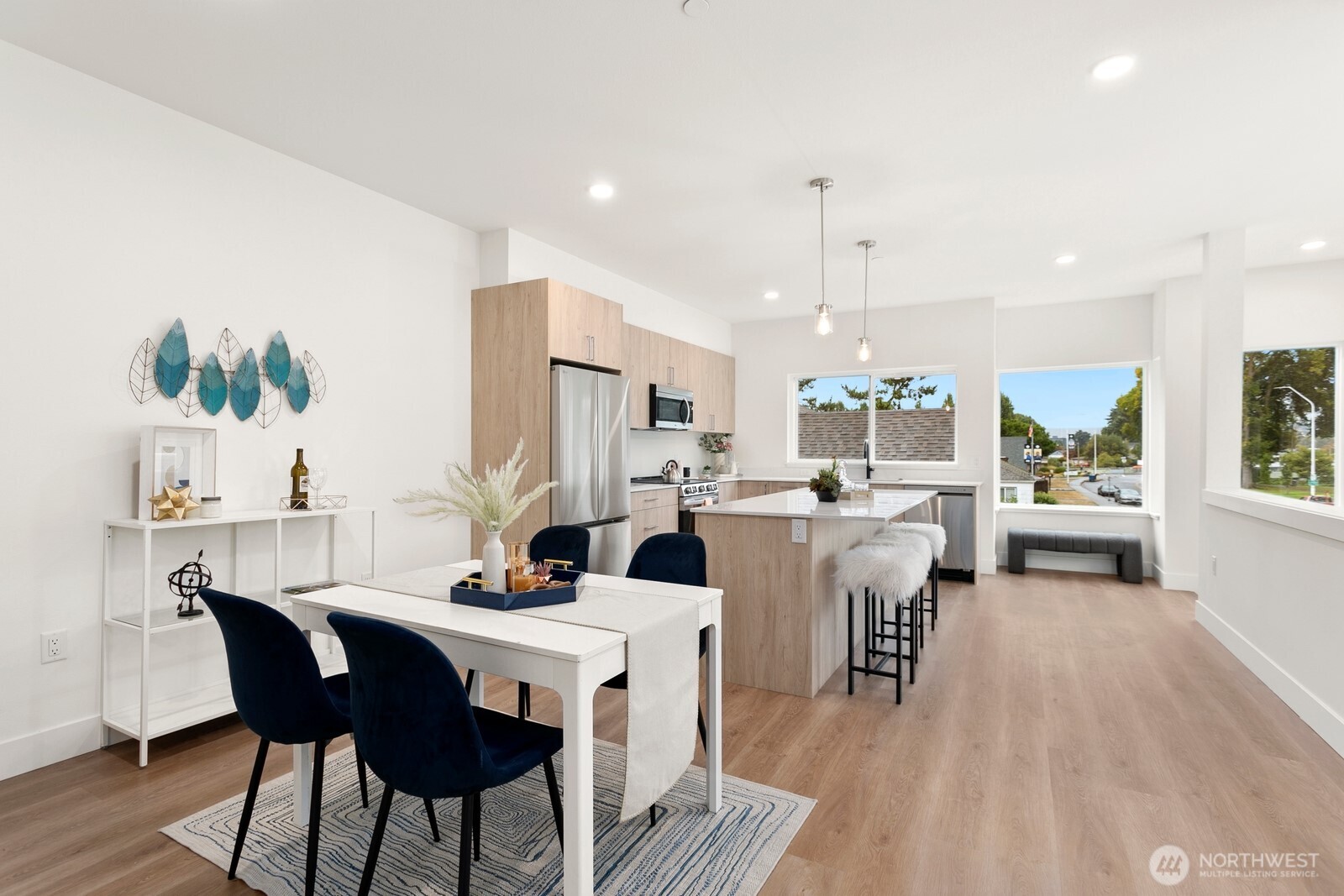 117 Wells Avenue South, Unit A Renton, WA 98057 - Photo 12 of 31 a view of a dining room with furniture window and wooden floor