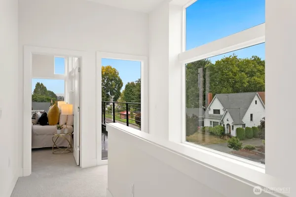 a bedroom with furniture and a large window