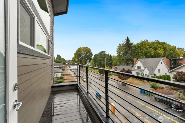 a view of a balcony with wooden floor and fence