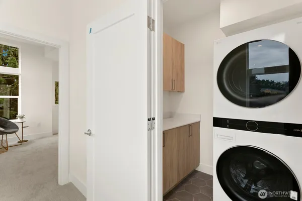 a view of a hallway with washer and dryer