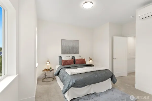 a bedroom with a bed and a night stand