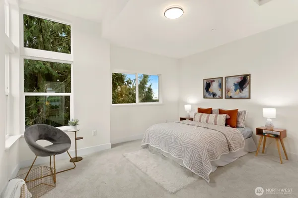 a bedroom with a bed and a chair
