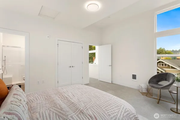 a bedroom with a bed and a chair