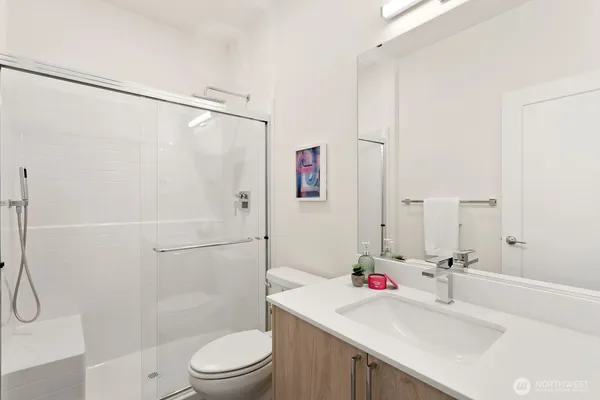 a bathroom with a sink toilet and shower