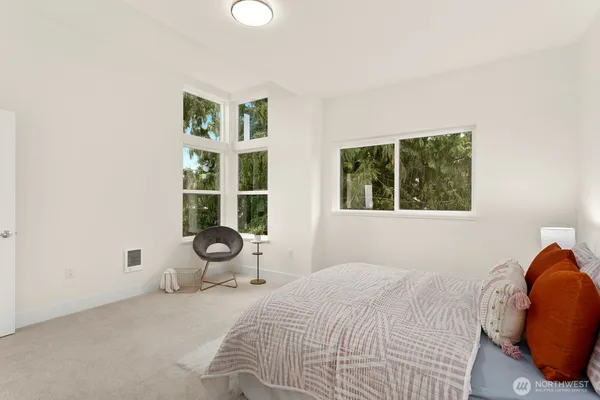 a bedroom with a bed and glass windows