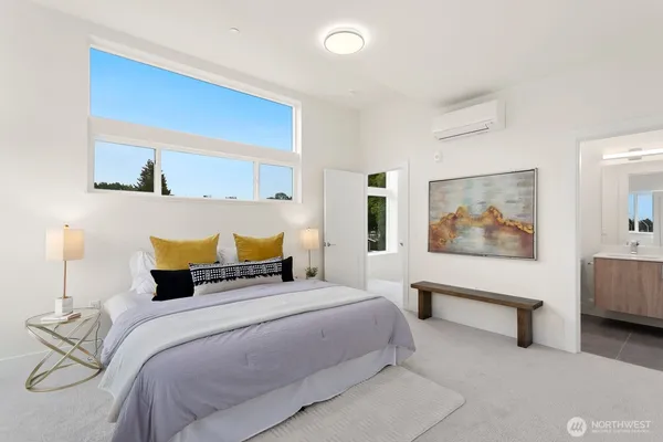 a bedroom with a bed and a painting on the wall