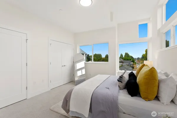 a bed room with a bed and a painting on the wall