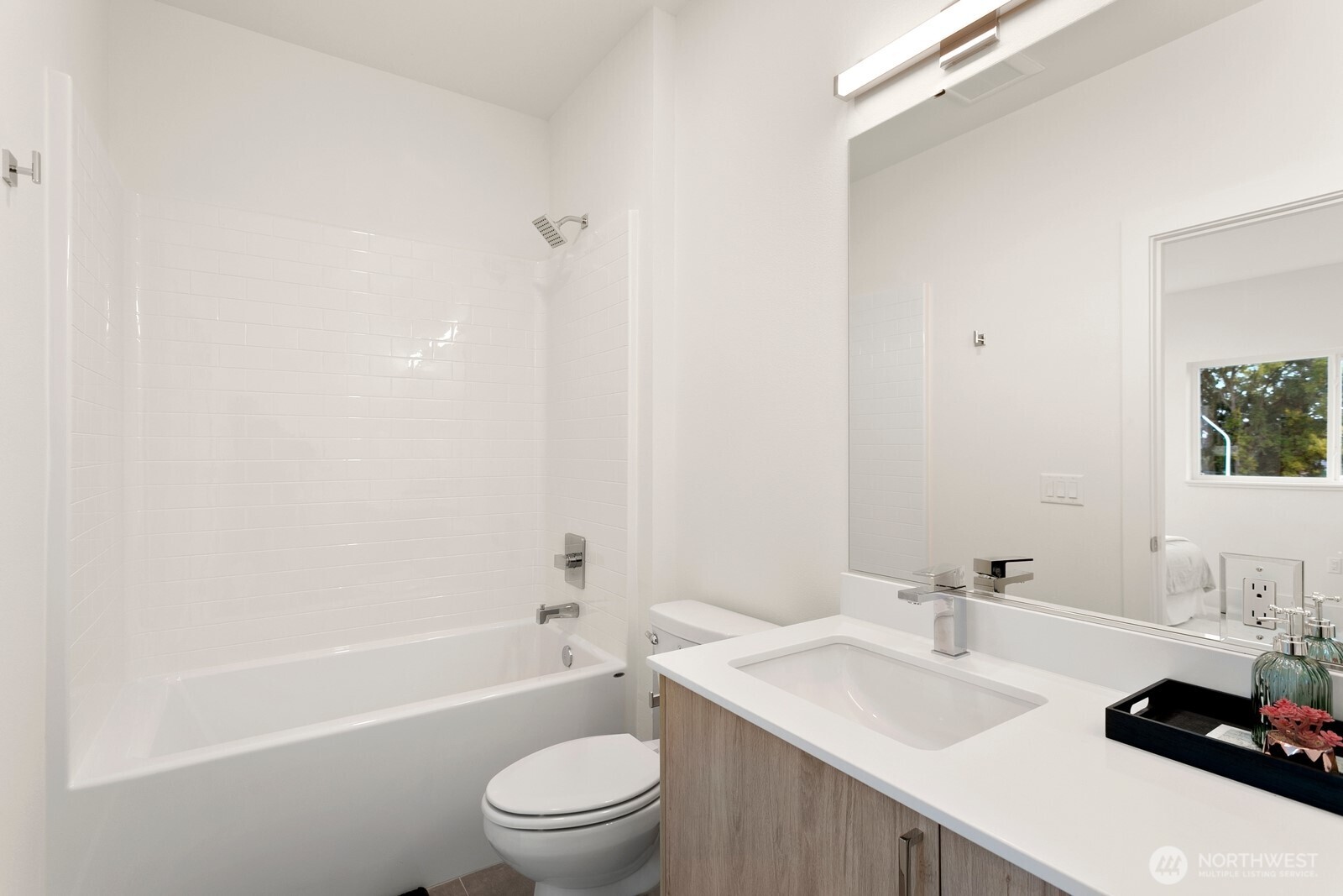 117 Wells Avenue South, Unit A Renton, WA 98057 - Photo 28 of 31 a bathroom with a sink a toilet and shower