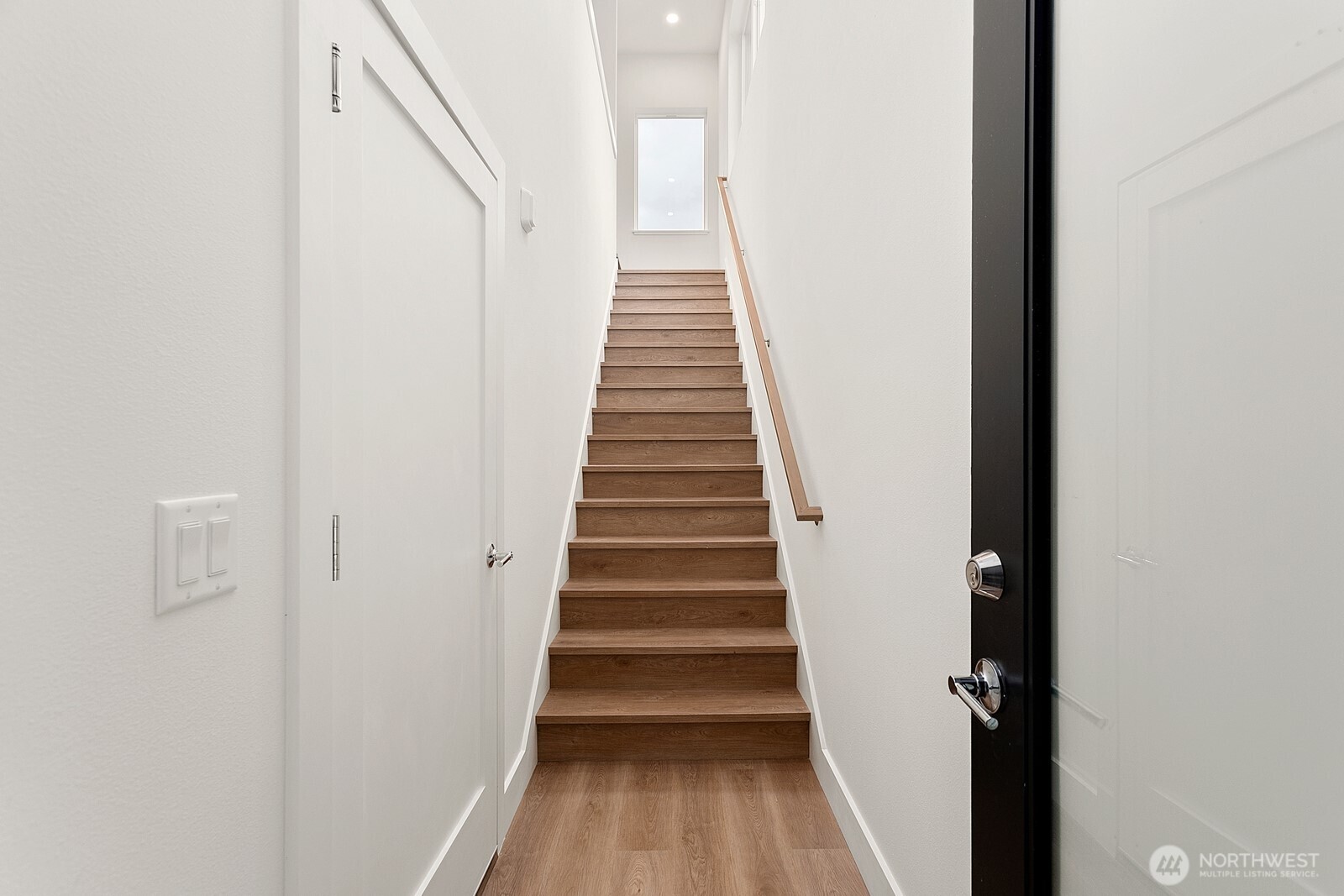117 Wells Avenue South, Unit A Renton, WA 98057 - Photo 6 of 31 a view of a hallway with wooden floor and entryway