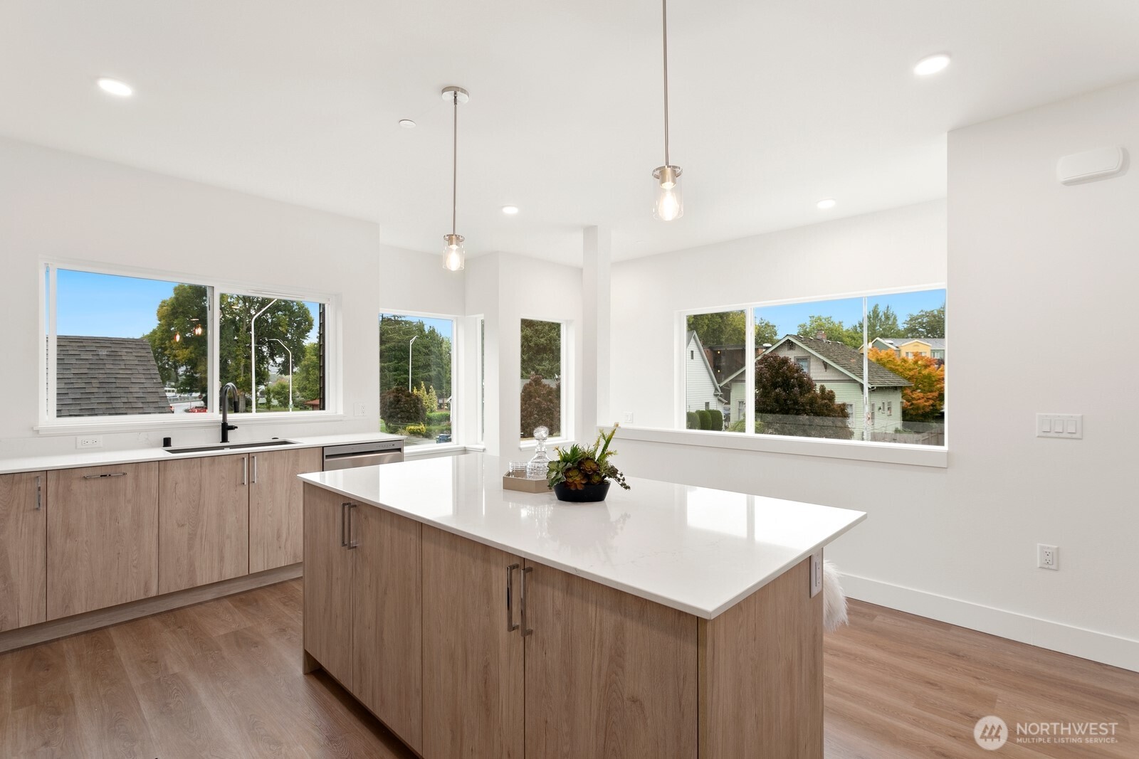 117 Wells Avenue South, Unit A Renton, WA 98057 - Photo 8 of 31 a kitchen with stainless steel appliances a large window and cabinets