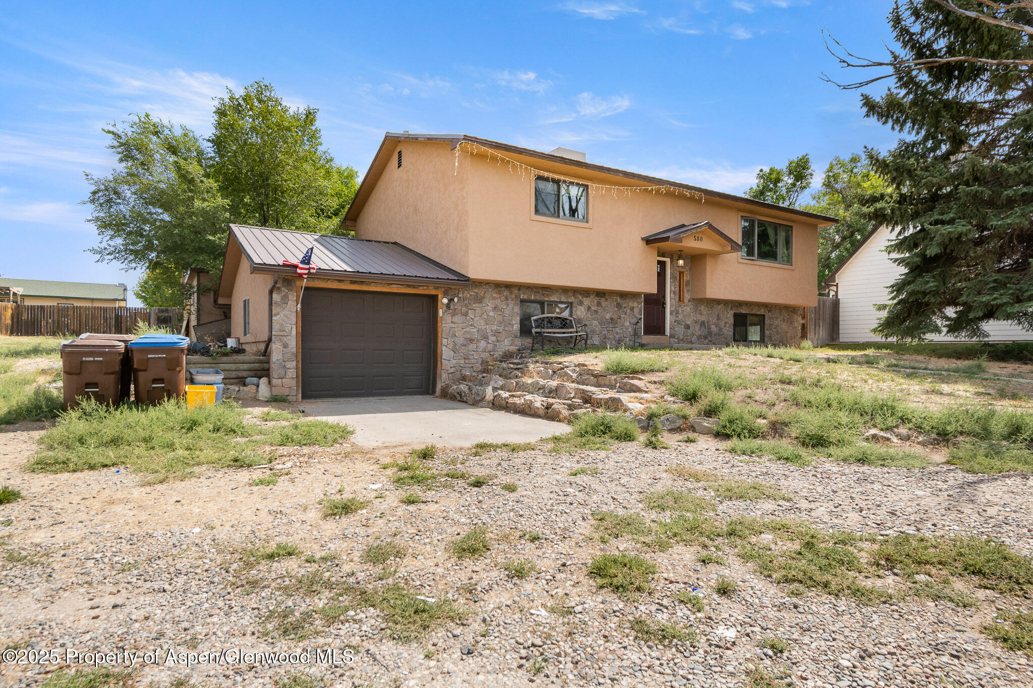 580 Will Avenue Rifle, CO 81650 - Photo 2 of 24 a front view of a house with a yard