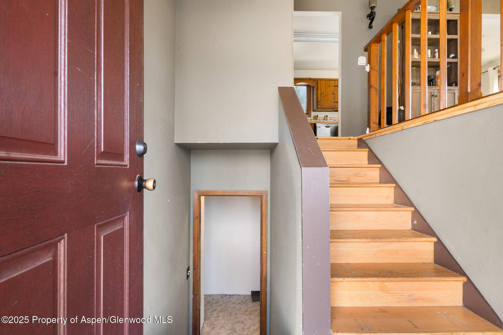 580 Will Avenue Rifle, CO 81650 - Photo 3 of 24 a view of staircase with lots of frames on wall and windows