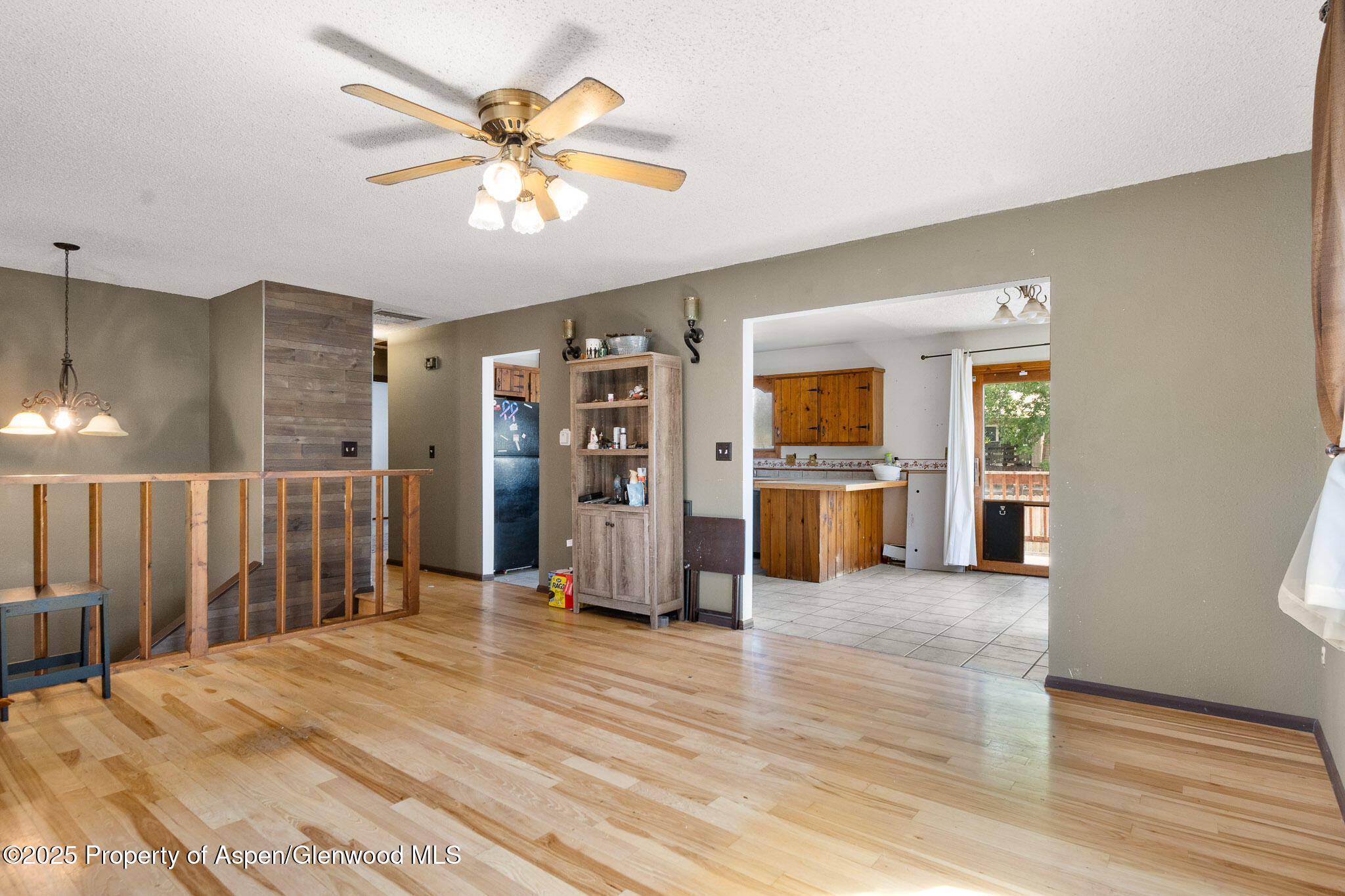 580 Will Avenue Rifle, CO 81650 - Photo 5 of 24 a view of a livingroom with wooden floor and a ceiling fan