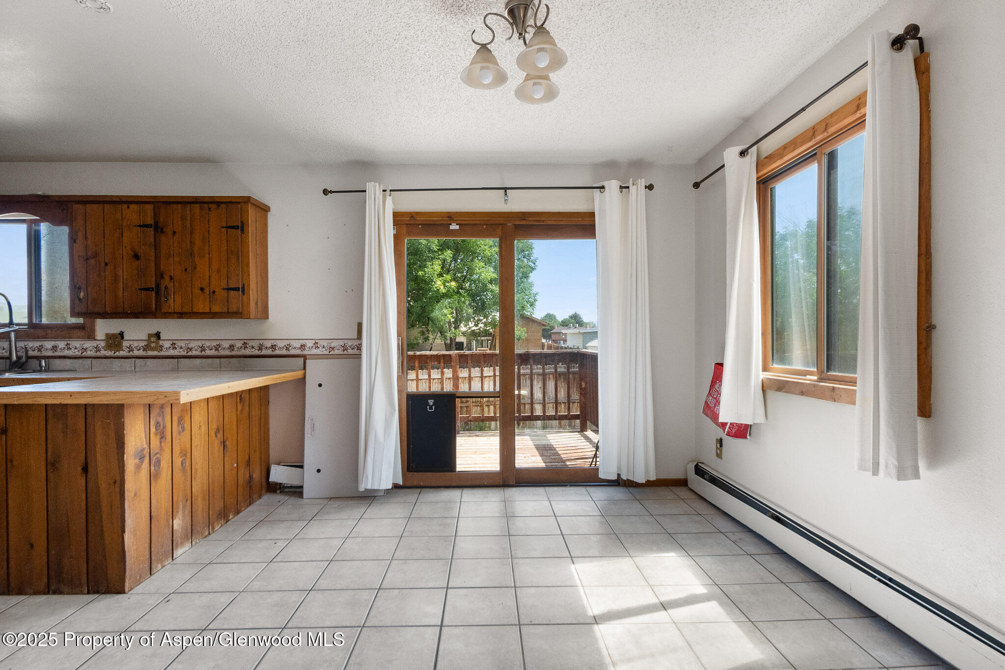 580 Will Avenue Rifle, CO 81650 - Photo 7 of 24 a bathroom with a granite countertop sink mirror and a tub