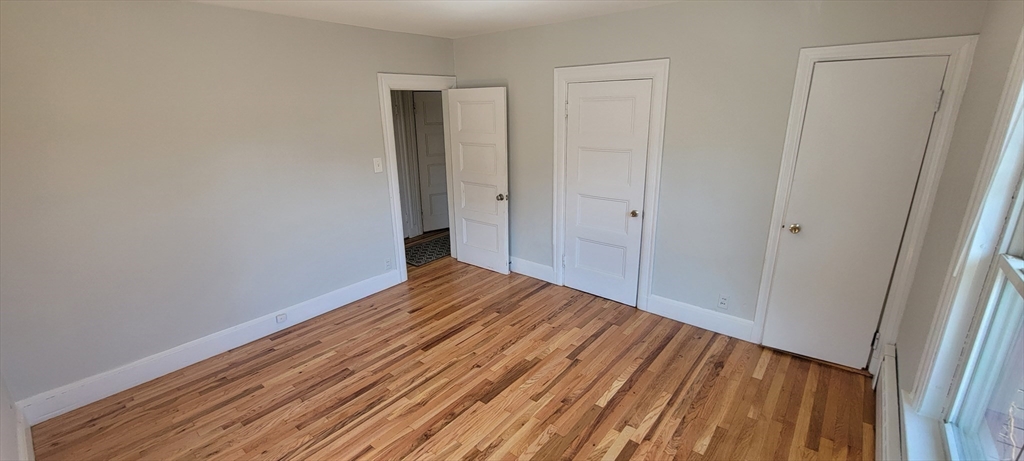 88 Corey Street, Unit 2 Boston, MA 02132 - Photo 12 of 23 a view of a room with wooden floor