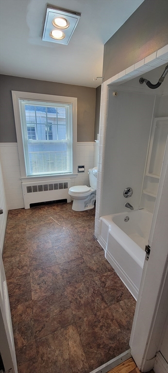 88 Corey Street, Unit 2 Boston, MA 02132 - Photo 15 of 23 a bathroom with a tub sink and a mirror