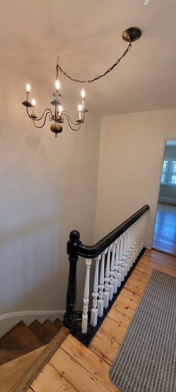 88 Corey Street, Unit 2 Boston, MA 02132 - Photo 18 of 23 a view of a hallway with wooden floor and staircase