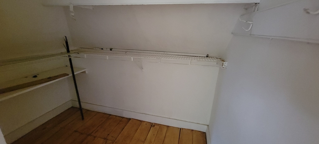 88 Corey Street, Unit 2 Boston, MA 02132 - Photo 22 of 23 a view of storage and utility room with racks on the wall