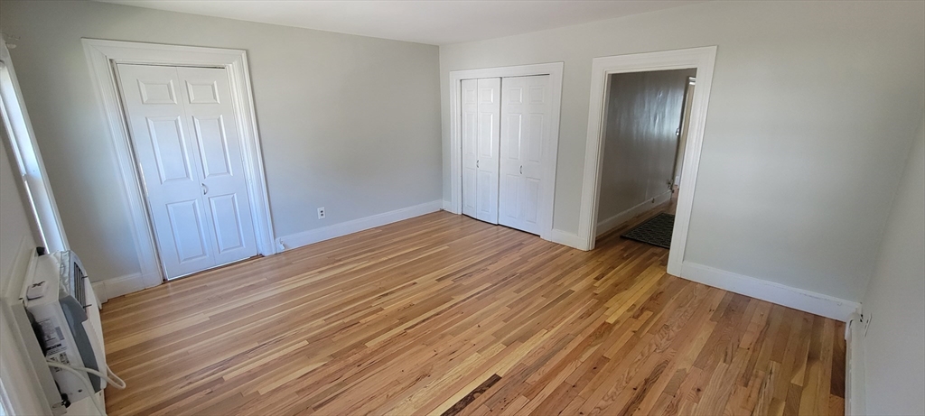 88 Corey Street, Unit 2 Boston, MA 02132 - Photo 4 of 23 a view of a room with wooden floor