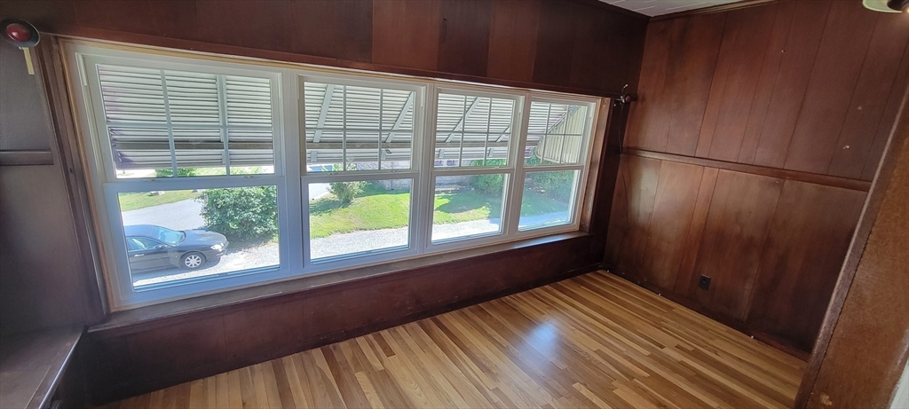 88 Corey Street, Unit 2 Boston, MA 02132 - Photo 8 of 23 a view of empty room with wooden floor and a window